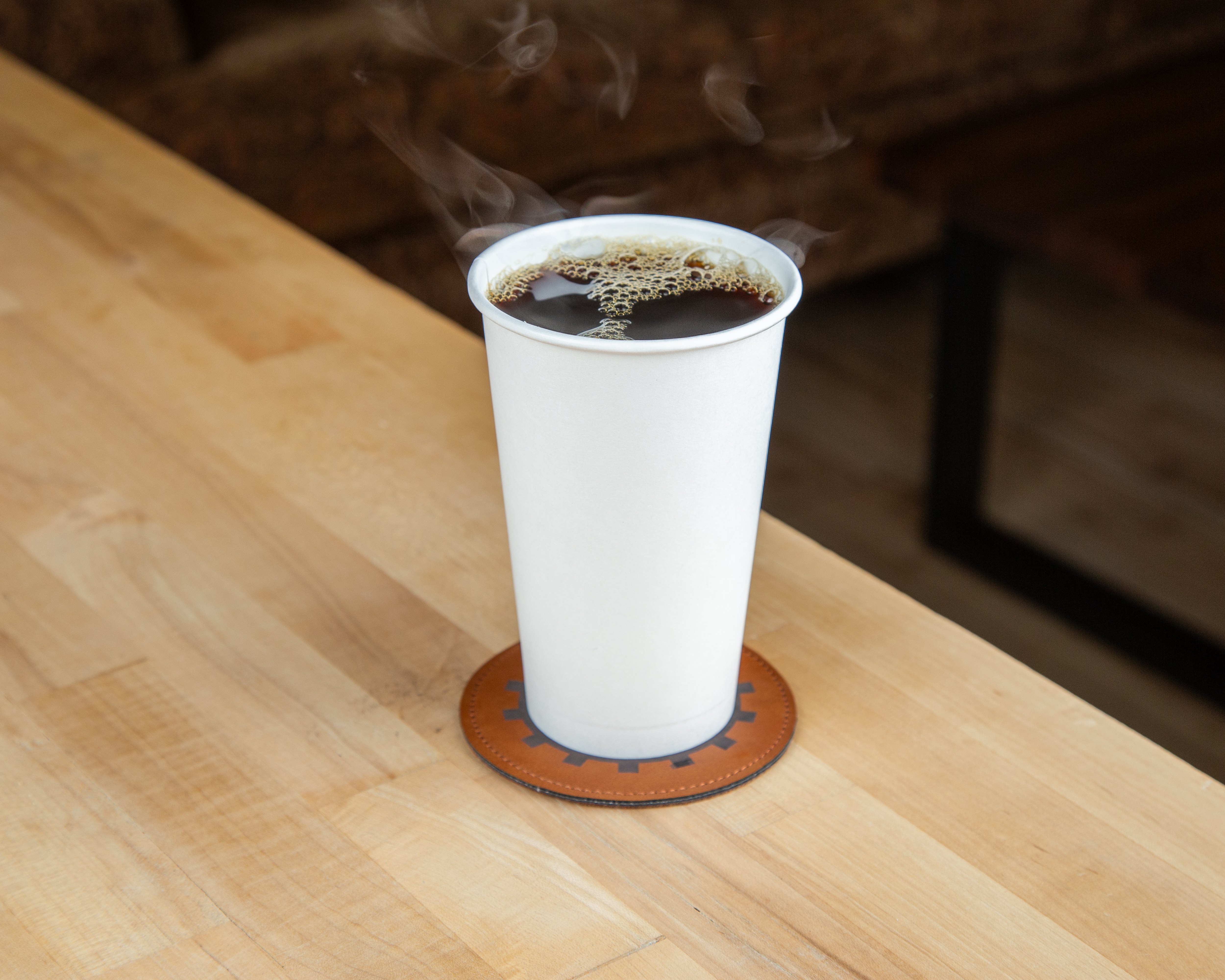 Freshly brewed hot coffee steaming on a Vault 223 coaster
