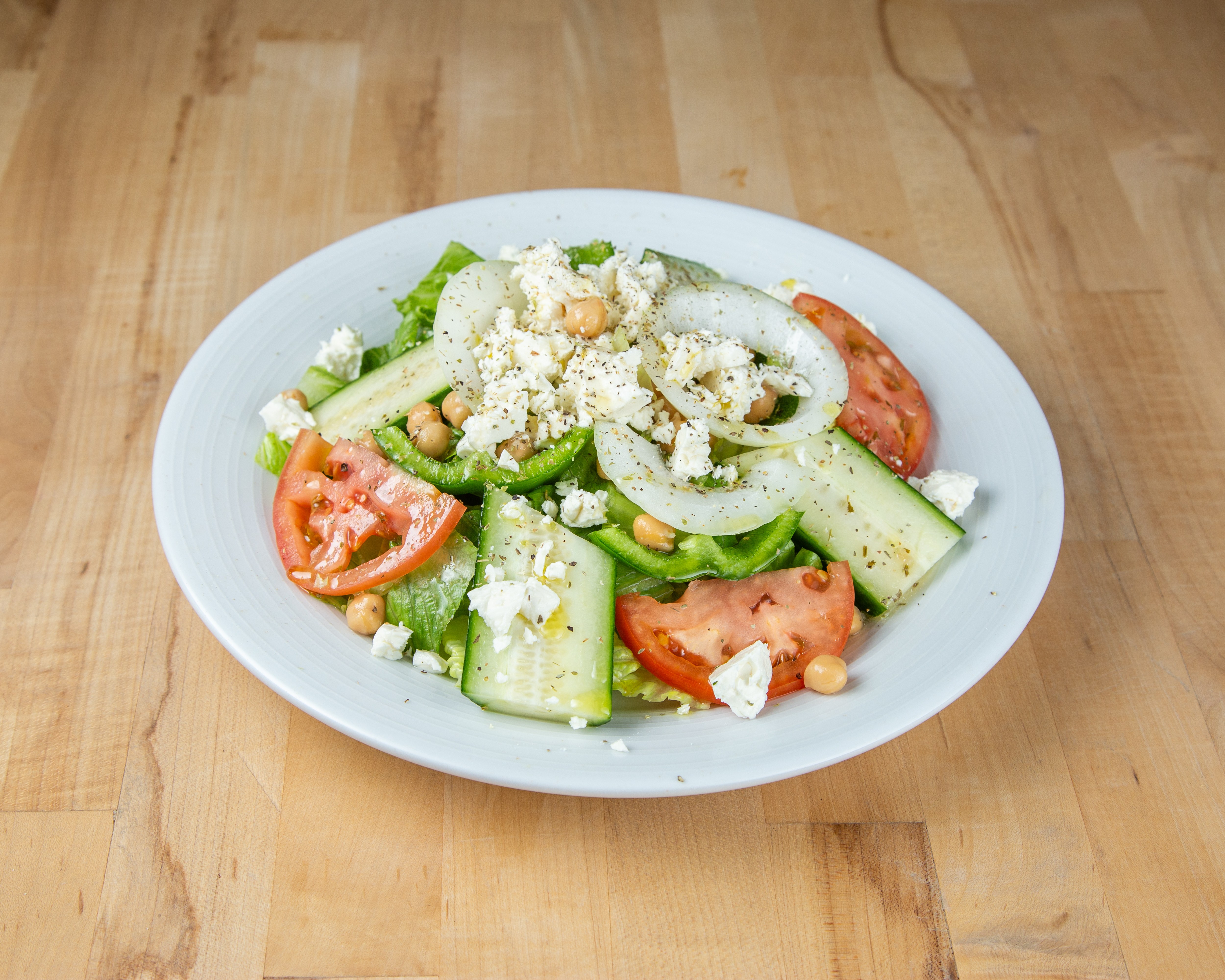 Mediterranean salad with cucumber, tomato, feta, and chickpeas